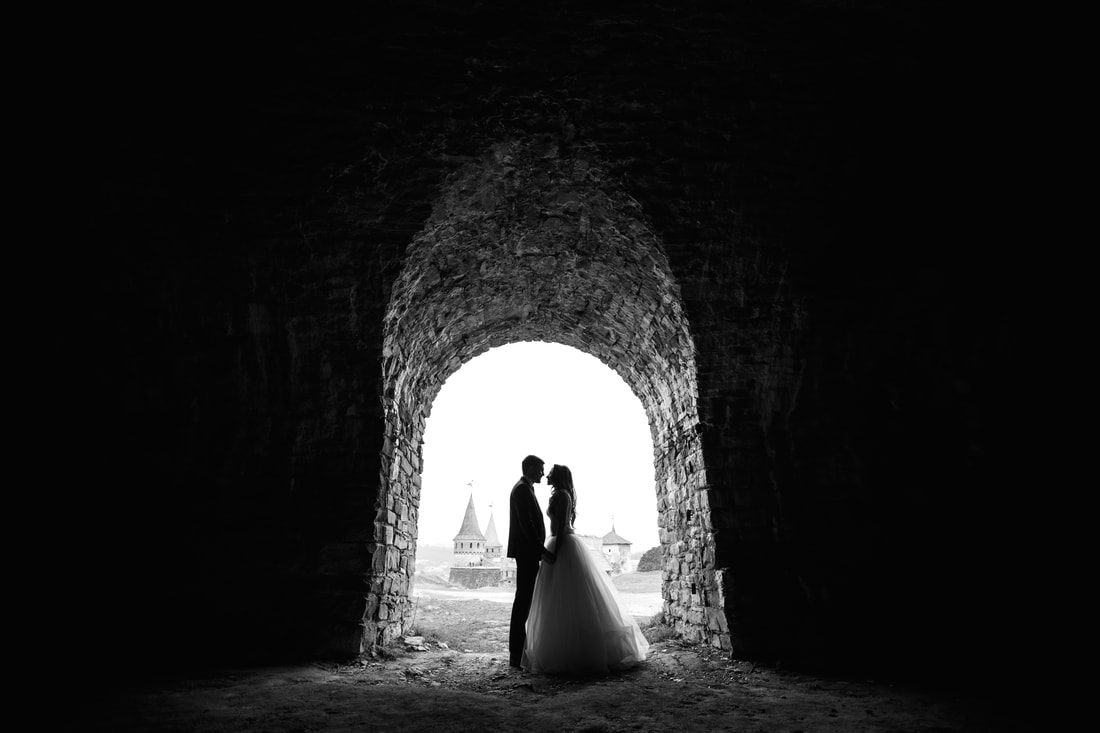 Bride and groom under an arch