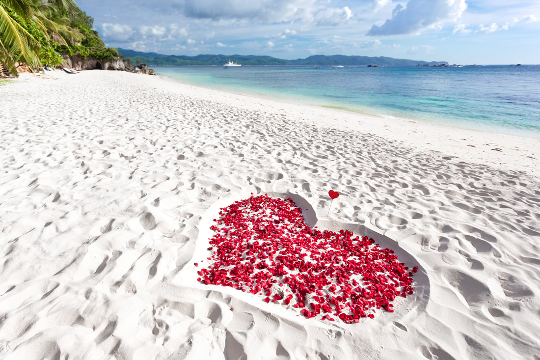 Heart made of rose petals on the beach