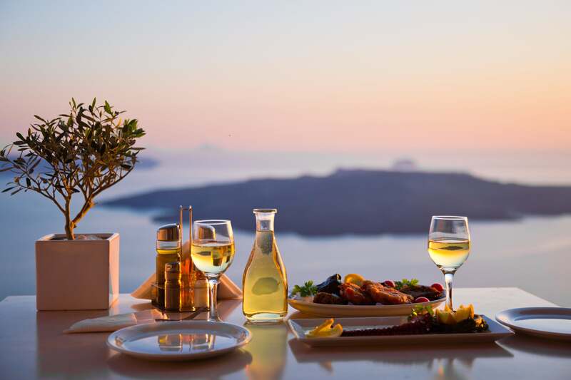 meal with wine overlooking Greek island